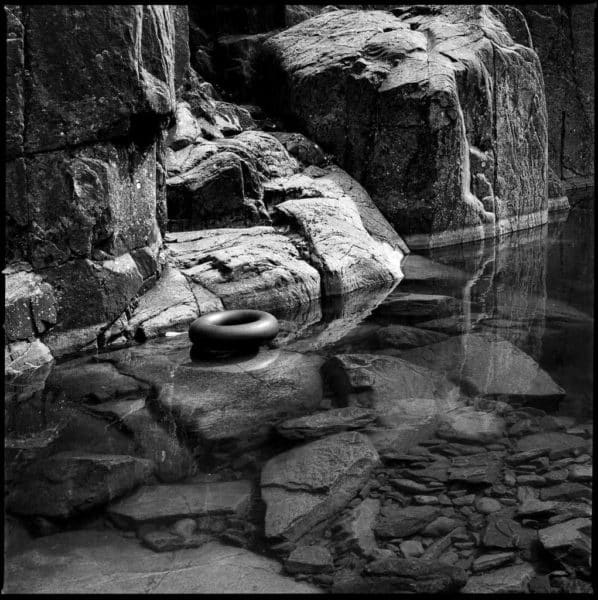 Rubber ring and reflections at Parsons Falls on Delta 100 film