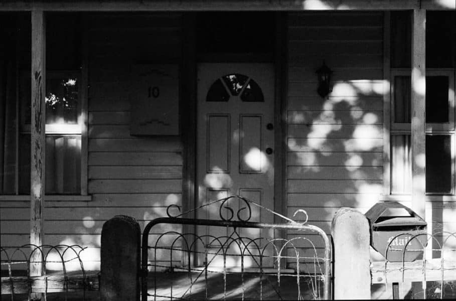 Dappled sunlight on a suburban cottage. Shot on Tri-X by Jade Austen Tasmania